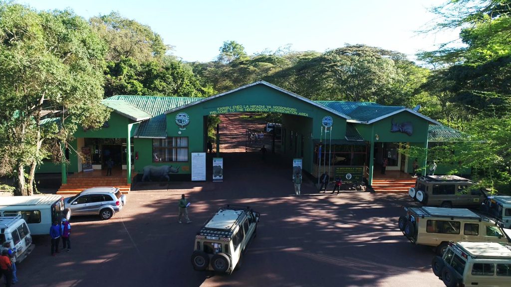 Ngorongoro Conservation Area park gate with safari vehicles
